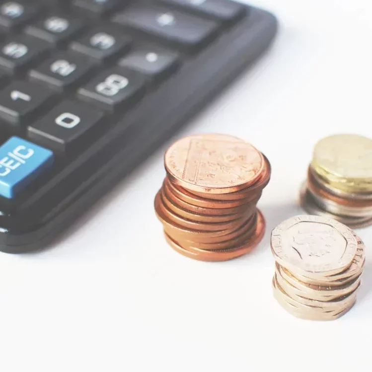 picture of coins in a stack and a calculator